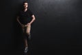 Full length portrait of happy handsome young man on black background. Royalty Free Stock Photo