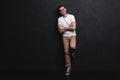 Full length portrait of happy handsome young man isolated on black background. Royalty Free Stock Photo