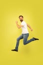 Full length portrait of happy jumping man on yellow background Royalty Free Stock Photo