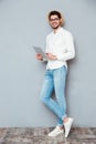 Full length portrait of a happy man using tablet computer Royalty Free Stock Photo