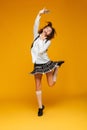 Full length portrait of a happy teenage schoolgirl in uniform Royalty Free Stock Photo