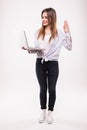 Full length portrait of a happy woman using laptop computer isolated on a white Royalty Free Stock Photo