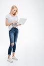 Full length portrait of a happy woman using laptop computer Royalty Free Stock Photo