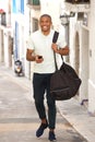 Happy young african man walking on road Royalty Free Stock Photo