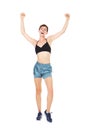 Full length happy young exercise woman with arms raised
