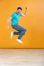 Full length portrait of a happy young man jumping Royalty Free Stock Photo