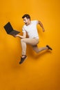 Full length portrait of a happy young man jumping Royalty Free Stock Photo