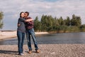 Happy age difference couple on beach on sunny windy day Royalty Free Stock Photo