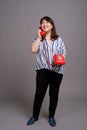 Full length portrait of Japanese businesswoman using phone Royalty Free Stock Photo