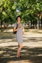 Amazing woman with a green cocktail. Vegan girl walking on a park background. Vegetarian lifestyle concept. Copy space. Royalty Free Stock Photo