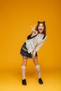 Full length portrait of a joyful teenage schoolgirl in uniform Royalty Free Stock Photo