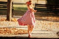 Full length portrait of a little girl dancing in the park a warm Royalty Free Stock Photo