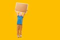 Full-length portrait of little girl in yellow blue clothes with an empty cork board in hands. Copy space, mockup Royalty Free Stock Photo