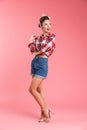 Full length portrait of a lovely beautiful brunette pin-up woman Royalty Free Stock Photo