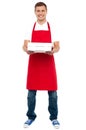 Full length portrait of male chef holding pie box Royalty Free Stock Photo