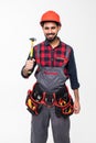 Portrait of a indian male manual worker working with hammer isolated against white background Royalty Free Stock Photo