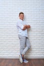 Full-length portrait of male in trendy fashion clothes leaning o Royalty Free Stock Photo