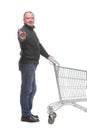 Full length portrait of a man returning an empty shopping cart Royalty Free Stock Photo