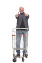 Full length portrait of a mature man returning an empty shopping cart Royalty Free Stock Photo