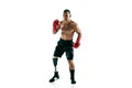 Full length portrait of muscular sportsman with prosthetic leg, copy space. Male boxer in red gloves. Royalty Free Stock Photo