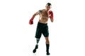 Full length portrait of muscular sportsman with prosthetic leg, copy space. Male boxer in red gloves. Royalty Free Stock Photo