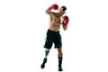 Full length portrait of muscular sportsman with prosthetic leg, copy space. Male boxer in red gloves. Royalty Free Stock Photo