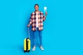 Full length portrait of nice young man suitcase tickets empty space wear shirt isolated on blue color background Royalty Free Stock Photo