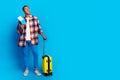 Full length portrait of nice young man suitcase tickets look empty space wear shirt  on blue color background Royalty Free Stock Photo