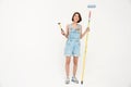 Full length portrait pretty girl, holding hammer and painting ro Royalty Free Stock Photo
