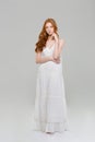 Full length portrait of a pretty redhead woman in dress Royalty Free Stock Photo