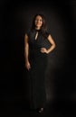 Portrait of a pretty young woman in a black long evening dress Royalty Free Stock Photo