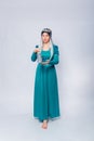 Full length portrait of a princess in a medieval, fantasy, turquoise dress with ash hair and a silver crown