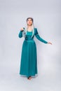 Full length portrait of a princess in a medieval, fantasy, turquoise dress with ash hair and a silver crown