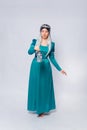 Full length portrait of a princess in a medieval, fantasy, turquoise dress with ash hair and a silver crown