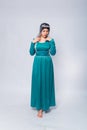 Full length portrait of a princess in a medieval, fantasy, turquoise dress with ash hair and a silver crown