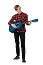 Full length portrait of proud boy teenager playing on the acoustic guitar isolated over white background. Music lessons for