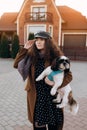 Stunning curly girl in dress posing with shi-tzu. Royalty Free Stock Photo