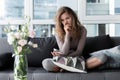 Sorrowful lady sitting on cozy sofa