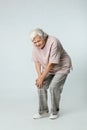 Full length portrait of senior woman having knee problems on grey Royalty Free Stock Photo