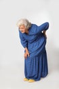 Full length portrait of senior woman having knee problems on grey Royalty Free Stock Photo