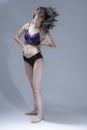 Full Length Portrait of Sensual Girl With Long Hair in Violet Nightie and Black Panties Demonstrating Long Hair and Posing on Gray