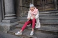 Confident senior lady sitting on steps of architectural landmark Royalty Free Stock Photo