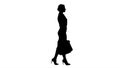 Silhouette Happy full length woman holding paper shopping bags in every hand and walking. Royalty Free Stock Photo