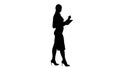 Silhouette Woman walking using digital tablet and talking to cam Royalty Free Stock Photo