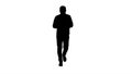 Silhouette Young man walking and using a phone, messaging. Royalty Free Stock Photo