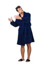 Full length portrait of sleepy young man messy hair, wears blue bathrobe eyes closed and hands outstretched like holding an Royalty Free Stock Photo