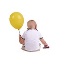 A little boy turned back with a big yellow balloon. Cute child paying a toy car isolated on a white background.