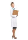 Full length portrait of smiling doctor woman with clipboard Royalty Free Stock Photo