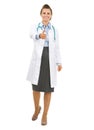 Full length portrait of smiling doctor woman stretching hand for Royalty Free Stock Photo