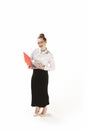 Full length portrait of a smiling female teacher holding a laptop isolated against white background Royalty Free Stock Photo